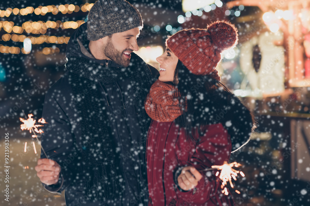 Sticker Portrait of his he her she nice attractive lovely charming cheerful cheery glad couple wearing warm outfit holding bengal sticks spending christmastime outdoor