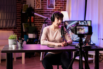 Vlogger recording internet show using professional camera, talking about entrepreneurship subjects. Influencer filming live broadcast for her audience using streaming equipment