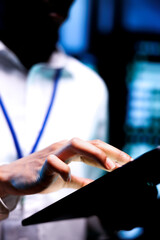 Close up shot of employee running data center hardware diagnostic tests to determine and service...