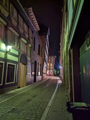 Beleutete Gasse mit Fachwerk Häusern bei Nacht