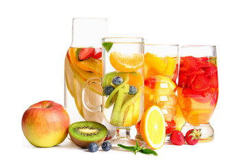 Glasses and bottle of infused water with different sliced fruits on white background