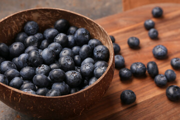 Bowl with sweet fresh blueberries on dark background