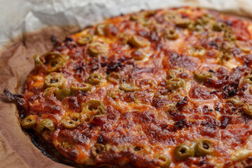 Freshly made pizza with tuna, cheese, tomato and olives