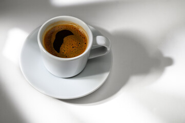 Cup of black coffee white background. Hot coffee in a cup.