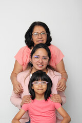 Grandmother, mom and daughter, three generations of dark-skinned Latina women show the importance of ancestors and female lineage on Mother's Day