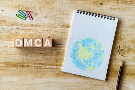 There is wood cube with the word DMCA. It is an abbreviation for Digital Millenium Copyright Act as eye-catching image.