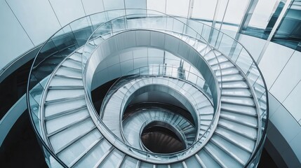 Spiral staircase inside a modern cylindrical building with glass floors