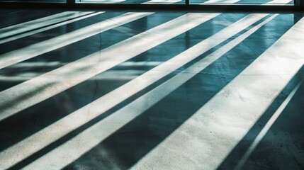Obraz premium Sunlight streams through a window, casting intricate shadows on a concrete floor, creating a modern, minimalist feel with geometric lines and abstract design