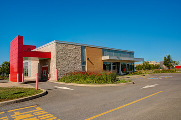 Bank drive thru on a summer day, clear blue sky in background.