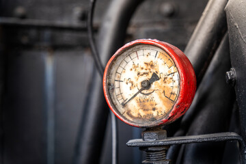 Valves and pressure gauge of a steam locomotive in a vintage railway workshop