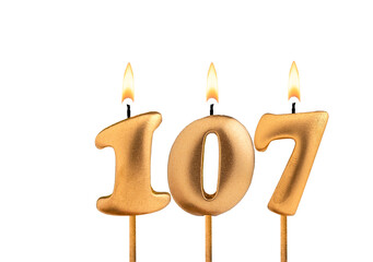 Birthday number 107 - Golden candle on white background
