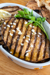 Italian style starter served in restaurant, grilled eggplant with garlic, olive oil and fresh parsley