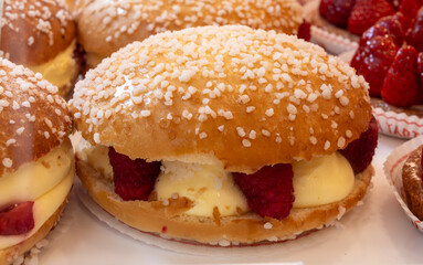 Cake Tarte tropezienne or La Tarte de Saint-Tropez - dessert pastry consisting of filled brioche with cream and fresh red berries