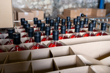 Storage of bottles of cognac spirit aged in French oak barrels in shop in distillery house, Cognac...