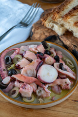 Tasty salad or starter seafood dish, grilled octopus ligurian style with green and black olives served in Italian  restaurant