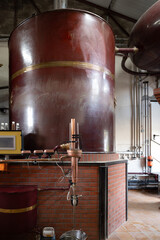 Naklejka premium Double distillation process of cognac spirit in Charentias copper alambic still pots and boilers in old distillery in Cognac white wine region, Charente, Segonzac, Grand Champagne, France