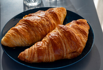 Fresh baked buttered croissants served in restaurant for continental or French breakfast close up