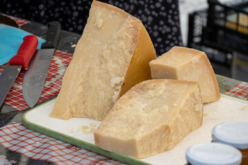 Traditional italian food, 36 months aged in caves Italian parmesan hard cheese from Parmigiano-Reggiano, Italy on farmers market