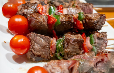 Typical snacks of Basque Country, pinchos or pinxtos skewers with small pieces of bread, fish, sea food, sweet green pepper served in bar in San-Sebastian or Bilbao, Spain