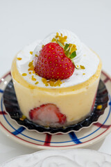 Red fruit sweet dessert cheesecake tart with fresh strawberries in bakery