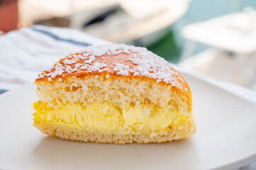 Cake of French Riviera, Tarte Tropezienne cake in yacht harbour of Port Grimaud, summer vacation in Provence, France