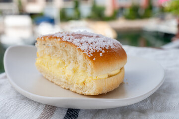 Cake of French Riviera, Tarte Tropezienne cake in yacht harbour of Port Grimaud, summer vacation in Provence, France