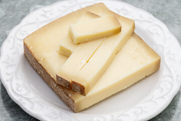 French cheese Comte, varieties unpasteurised ed milk Prestige, fruity flavoured Fruite and Vieille Reserve close up