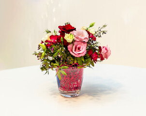 Bouquet of rose flowers in a vase on table