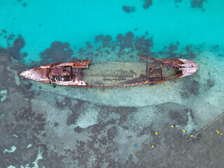 Shipwreck remote blue water tropical remote in Australia featuring snorkelers wearing yellow