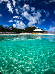 Tropical island from the water, aquamarine and turquoise blue in ripple patterns. Taken in Australia