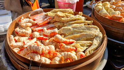 Tulungagung, Indonesia Oktober 25, 2024: The vendor serves various types of dim sum served in...