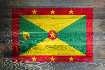 Fototapeta premium Grenada flag on rustic old wood surface background