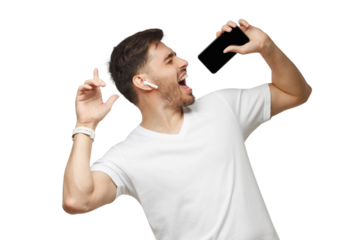 Young man in white t-shirt listening to music via wireless earphpones and singing in online karaoke app using phone