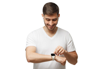 Young handsome man wearing white t-shirt and wireless earbuds, checking parameters or time on his smartwatch