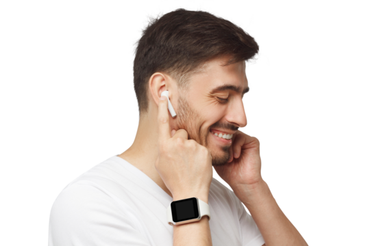 Side portrait of young handsome man in white t-shirt, wearing smartwatch and listening to music in wireless earphones