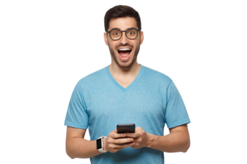 Young handsome manin blue t-shirt, wearing eyeglasses, holding phone in hands, looking at camera with excited WOW face