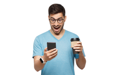 Portrait of young handsome man in blue t-shirt and glasses, with cup of coffee, looking at phone screen with shocked face
