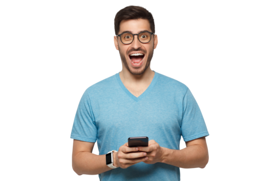 Young handsome manin blue t-shirt, wearing eyeglasses, holding phone in hands, looking at camera with excited WOW face