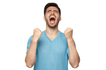 Young man shouting with closed eyes, celebrating victory, squeezing fists in deep emotional expression of happiness and luck