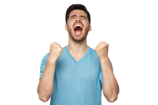 Young man shouting with closed eyes, celebrating victory, squeezing fists in deep emotional expression of happiness and luck