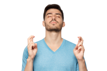 Young man with eyes closed and crossed fingers of both hands, wishing luck