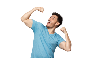 Young successful man in blue t-shirt screaming yes and raising clenched fist. People, success, winning and celebration concept
