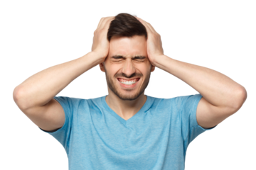 Portrait of young man suffering from severe headache, holding head with both hands, closed eyes with helpless face expression