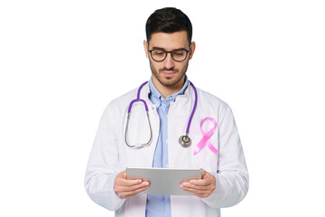 Young oncologist doctor with pink ribbon on his white coat looking at tablet, using app for medical check up. Breast cancer awareness month concept