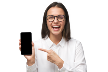 Laughing young woman showing funny content on screen of blank phone, pointing with finger, dressed in white collar shirt