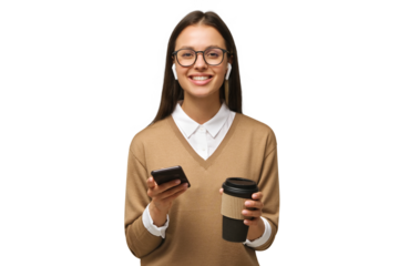 Young woman looking at camera while holding phone in one hand and coffee cup in another