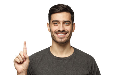 Handsome young man pointing up with his finger