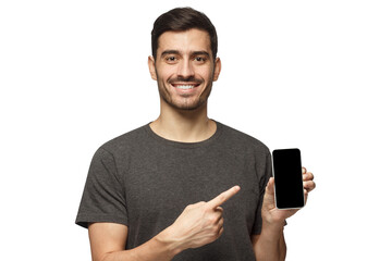 Portrait of happy man demonstrating blank phone and pointing to empty screen with smile. Copy space for yor app
