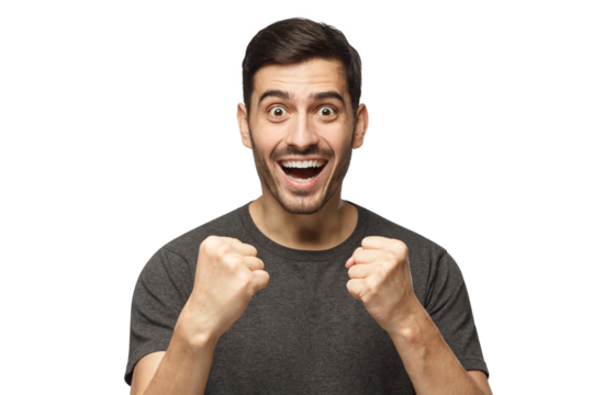 Young man celebrating victory as if he is winner, squeezing fists in deep emotional expression of happiness and luck