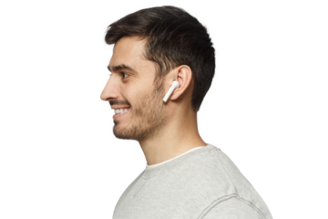 Side portrait of smiling young man listening to music, using wireless earphones